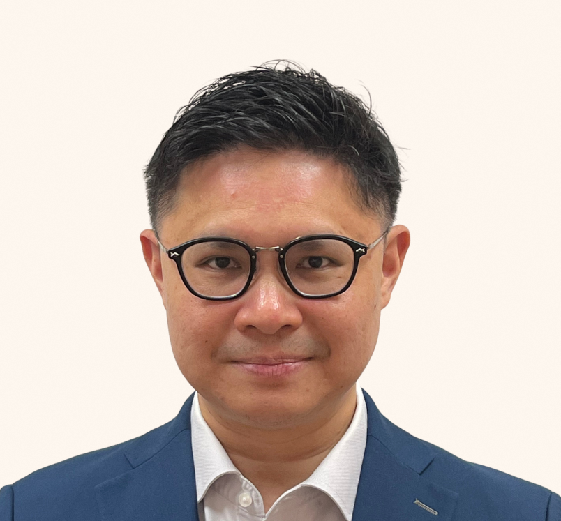 Minister of State Foo Cexiang in a navy blue blazer, smiling at the camera.